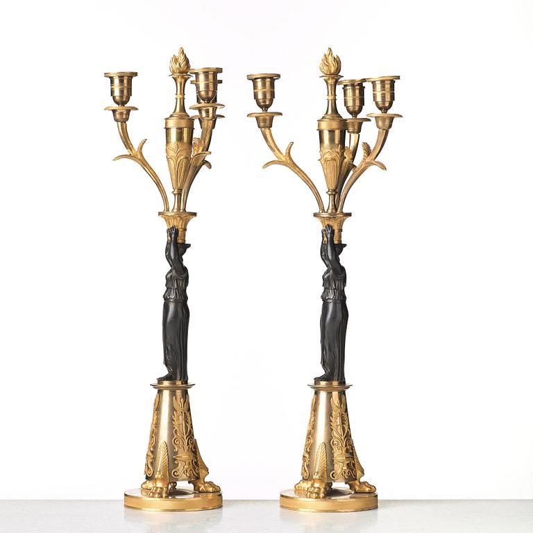 A pair of French Empire early 19th century three-light candelabra.