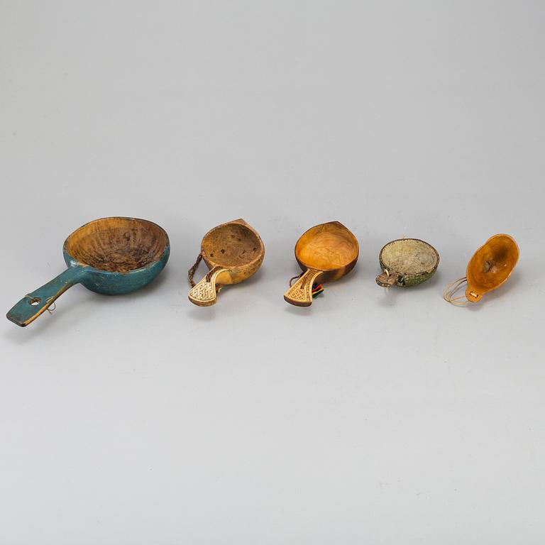 A set of five amongst others Sami cups made of birchwood and reindeer antlers.