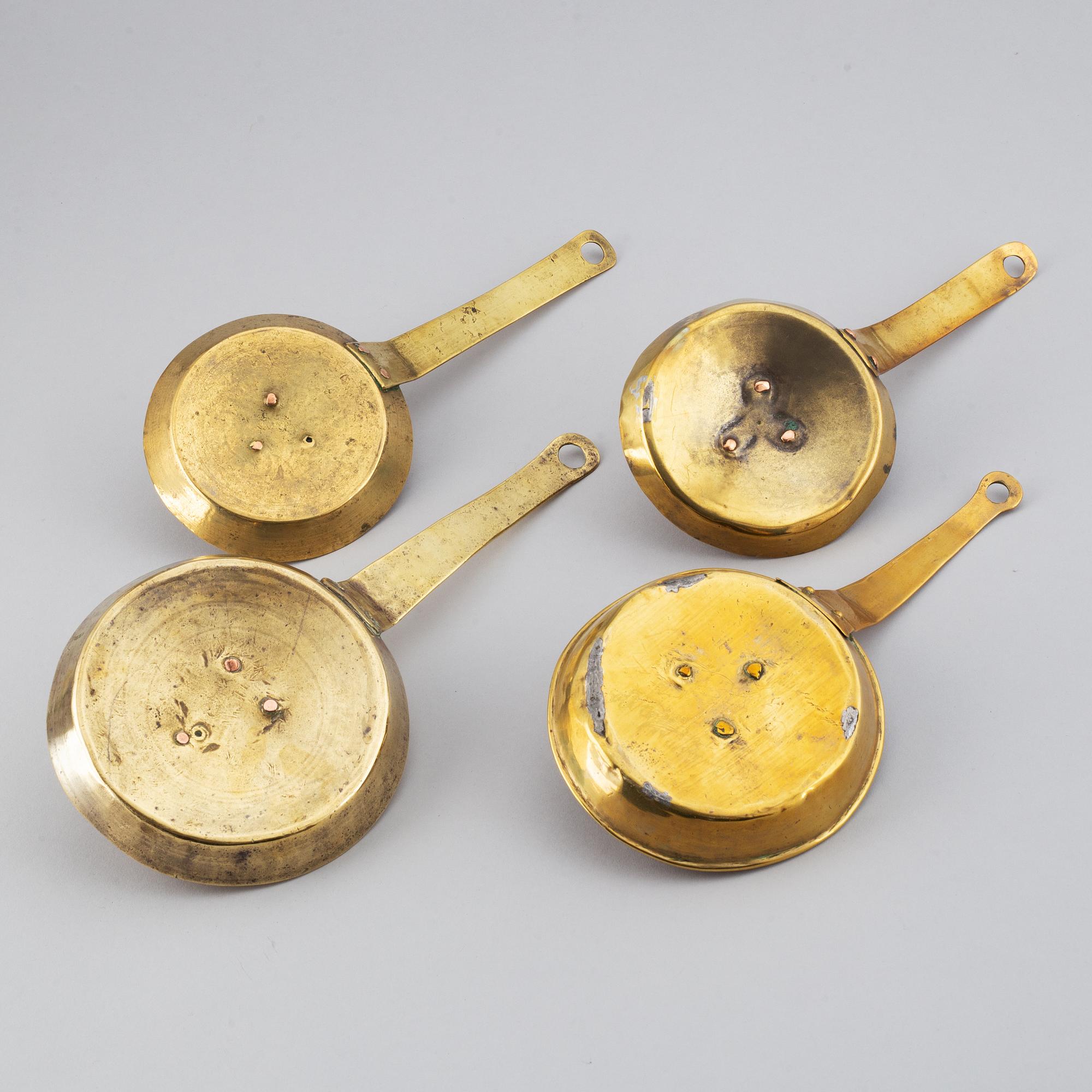 Four 18th century brass night light holders.