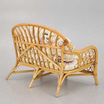 A rattan sofa and two armchairs, later part of the 20th century.