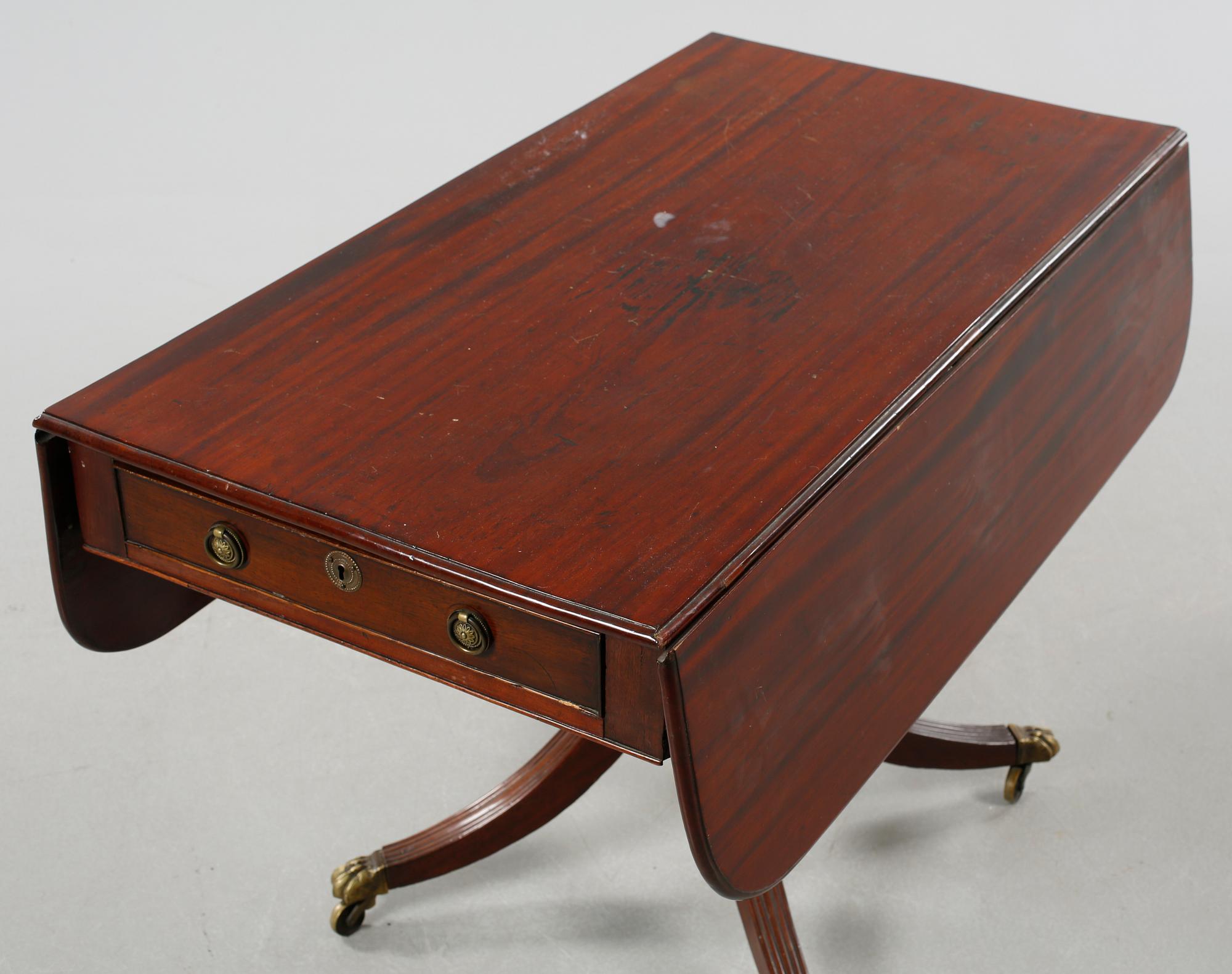 A drop-leaf table, English style, late 19th century.
