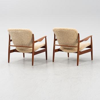 A pair of model FD 136 easy chairs with new sheepskin upholstery by Finn Juhl for France & Son, designed 1958.