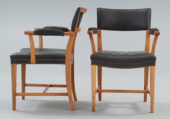 A pair of Josef Frank walnut and black leather armchairs, Svenskt Tenn, model 695.