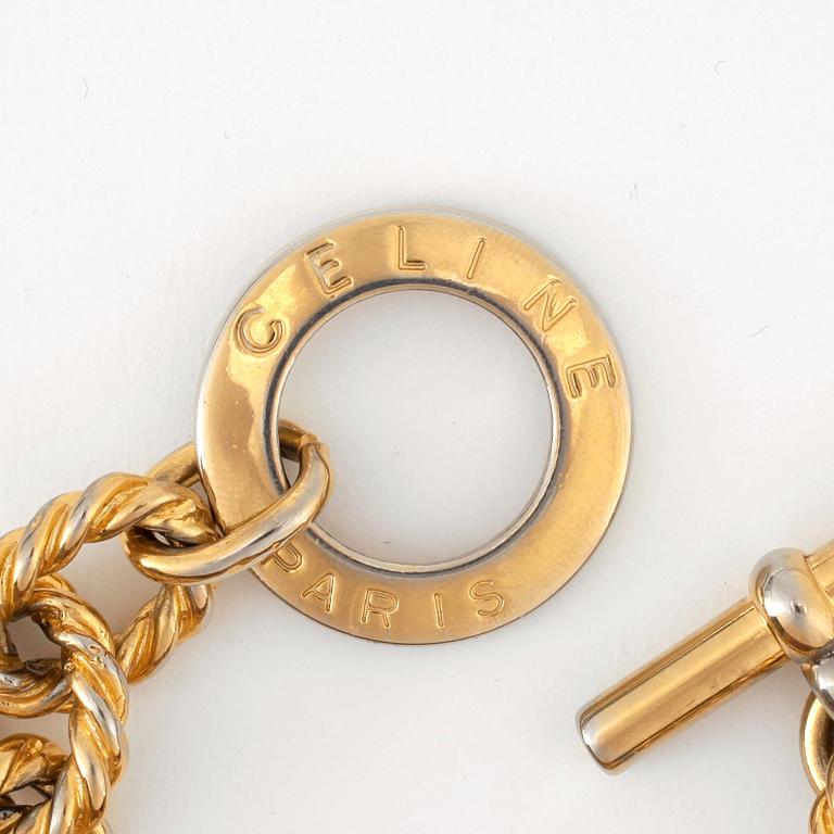 CÈLINE, a gold coloured bracelet.