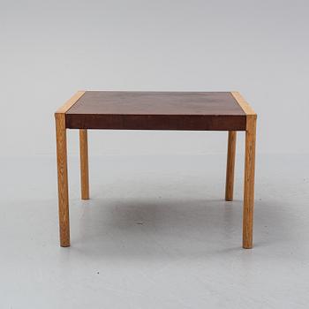 An oak and leather coffee table, mid 20th Century.