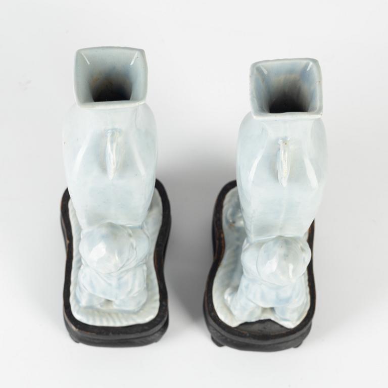 A pair of Chinese pale blue boys vases, around 1900.