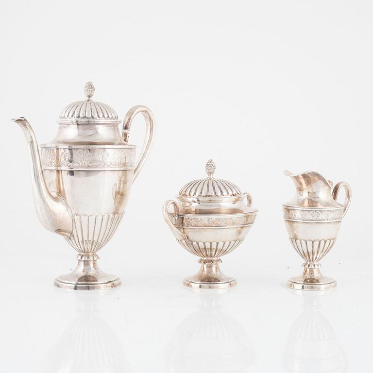 A Swedish Silver Coffee Pot, Creamer and Sugar Bowl, mark of CG Hallberg, Stockholm 1897.