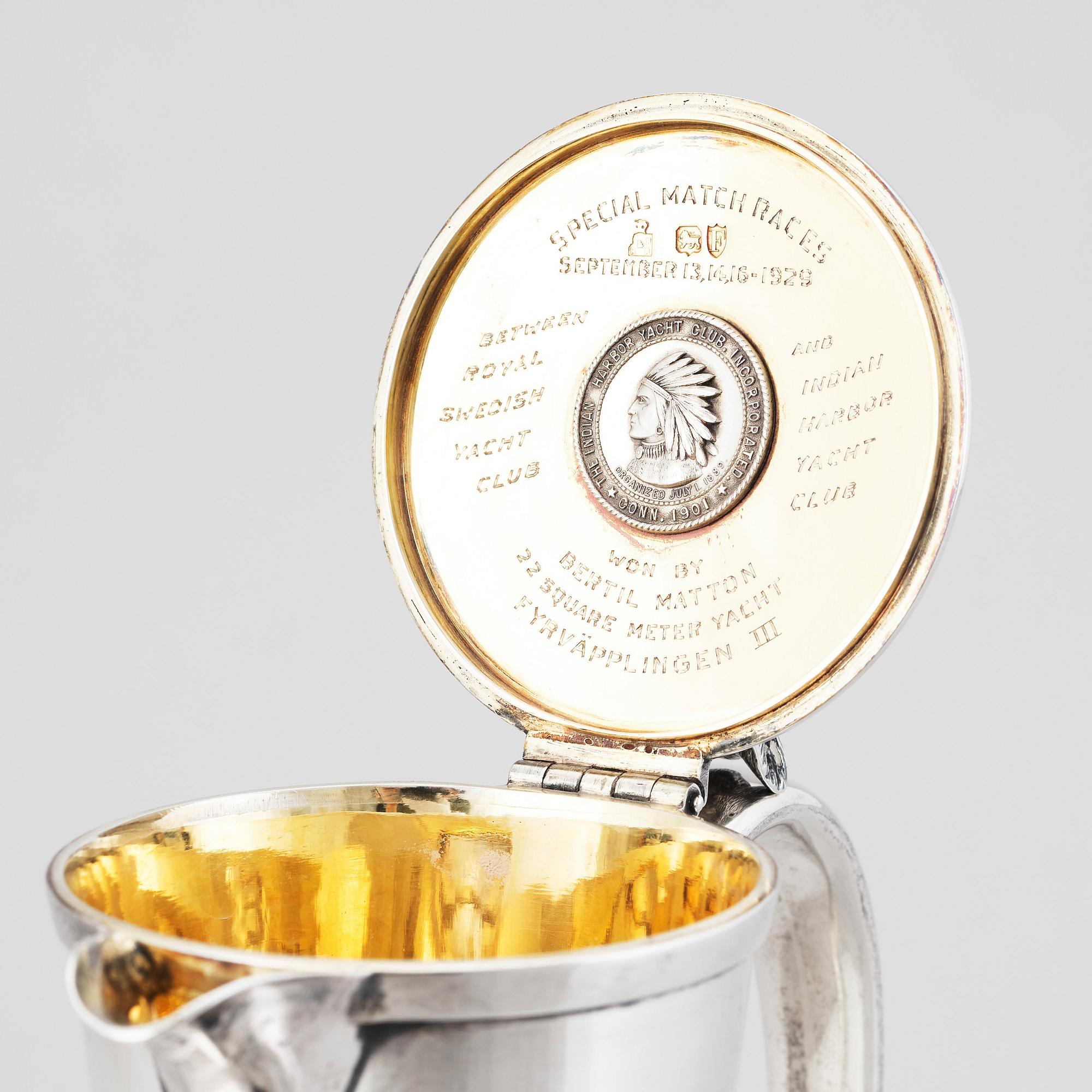 An English silver jug with lid, makers mark Hunt & Roskell Late Storr & Mortimer, London 1881.