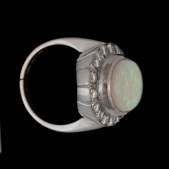 An opal, 9.97 cts, and diamond, 1.00 ct, ring. Weights according to engraving.