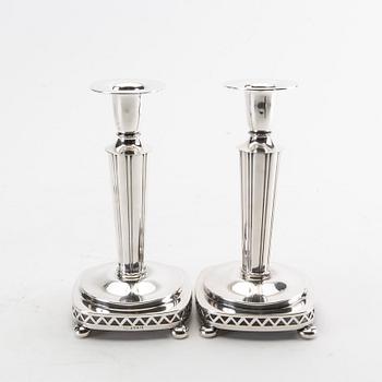 Two pairs of silver candle sticks from 1956 and 1992.