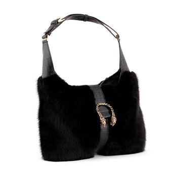 620. GUCCI, a black fur and crocodile shoulder bag.