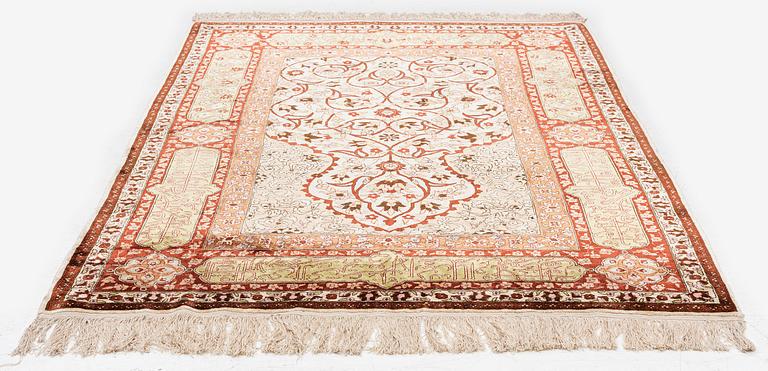 A semi-antique Turkish silk rug, c. 200 x 130 cm.