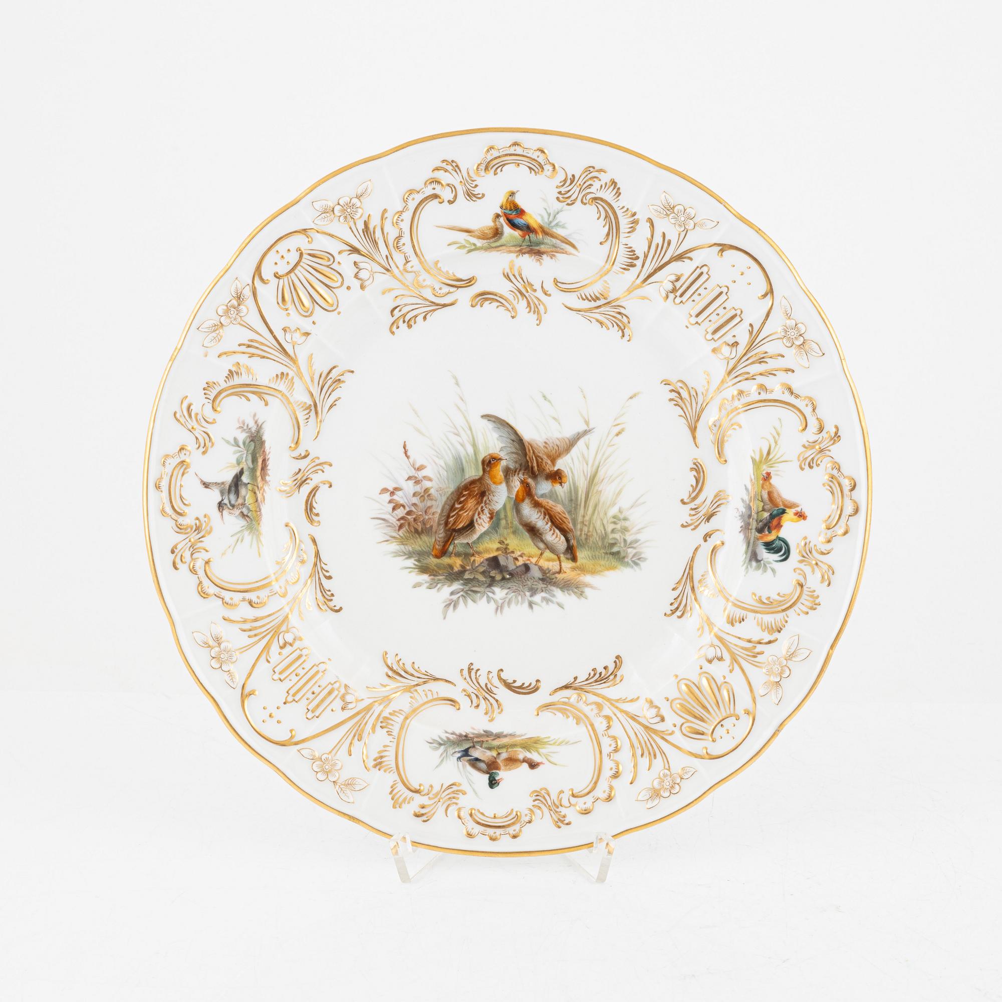 A set of five Meissen porcelain games plates, late 19th to early 20th century.