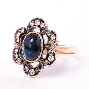 A 10-11K gold ring with a cabochon cut sapphire and old cut diamonds ca. 0.35 ct in total.