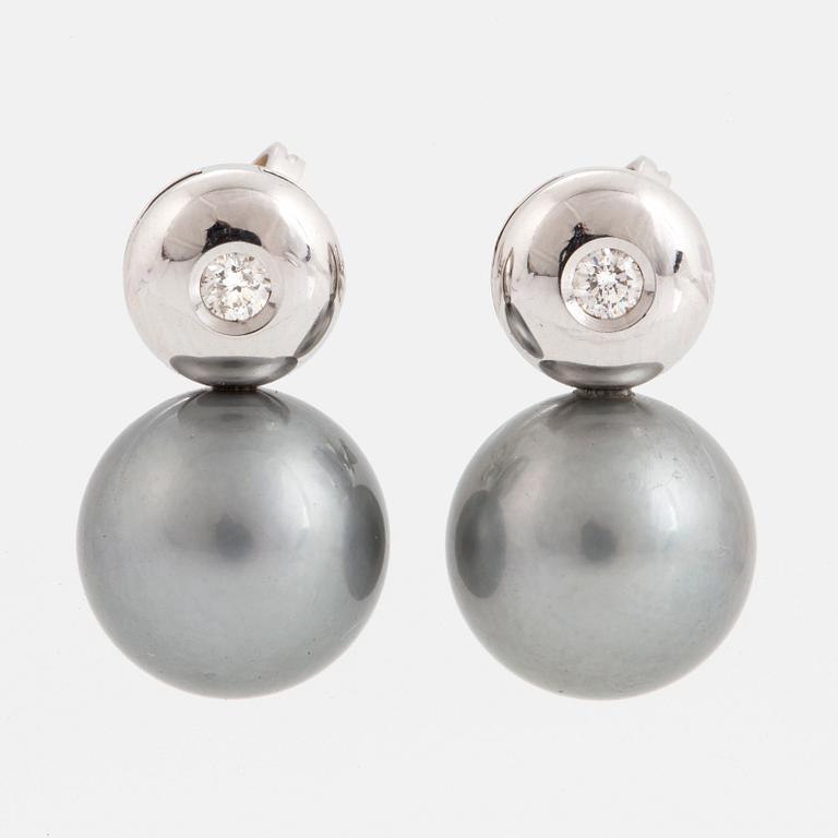 Cultured Tahiti pearl earrings with brilliant-cut diamonds.