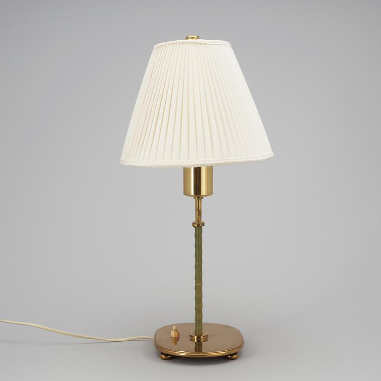 A Josef Frank brass and green leather table lamp by Svenskt Tenn.