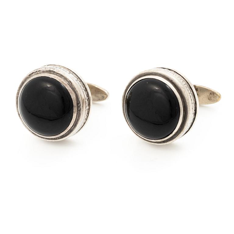 Cufflinks, a pair in silver with cabochon-cut stones.