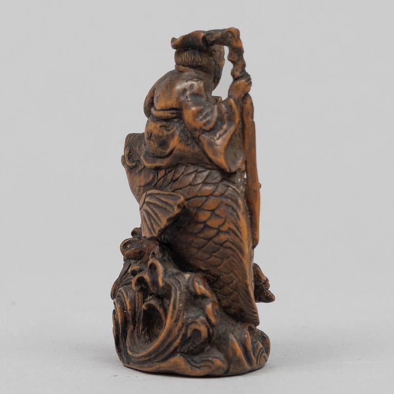 A Japanese carved wooden netsuke, Meiji (1868-1912). Signed.