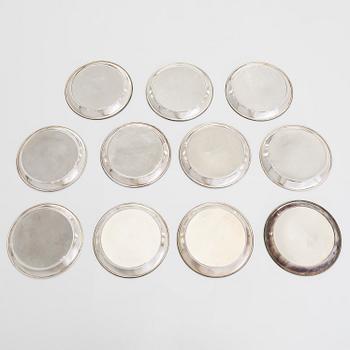 A 21-piece set of 'Chippendale' silver cutlery, and 11 silver coaster, Turku and Hämeenlinna, 1983-90 and 1964.