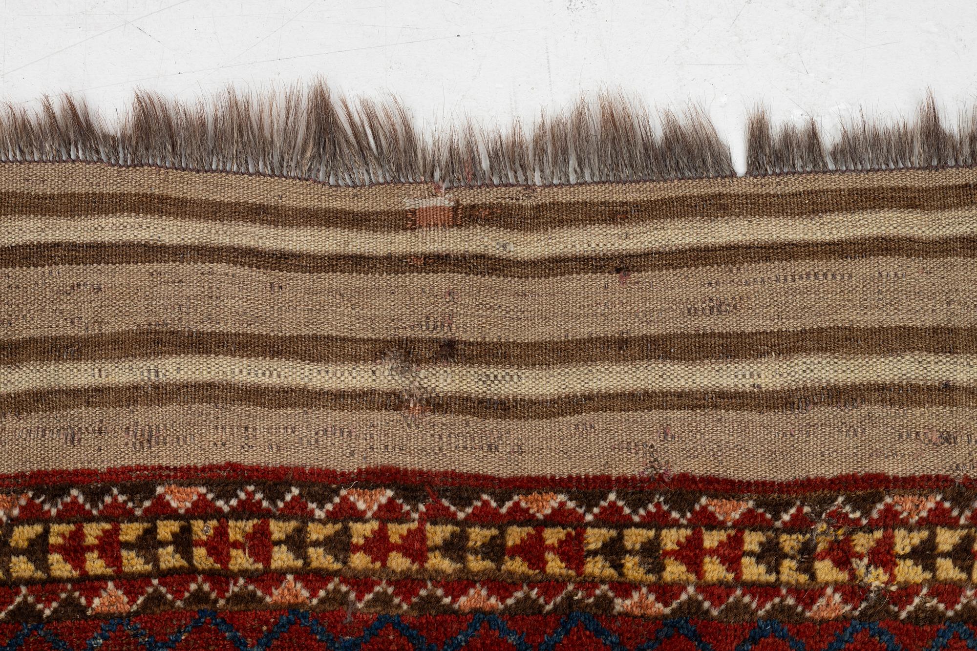 An antique Beshir carpet, ca 495 x 206 cm, around the year 1875.