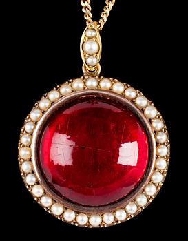 990. A red amber pendant, turn of century 1900.