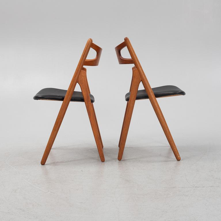 Hans J Wegner, a pair oak and teak CH29 'Savbukkestolen' chairs,Carl Hansen, mid 20th century.