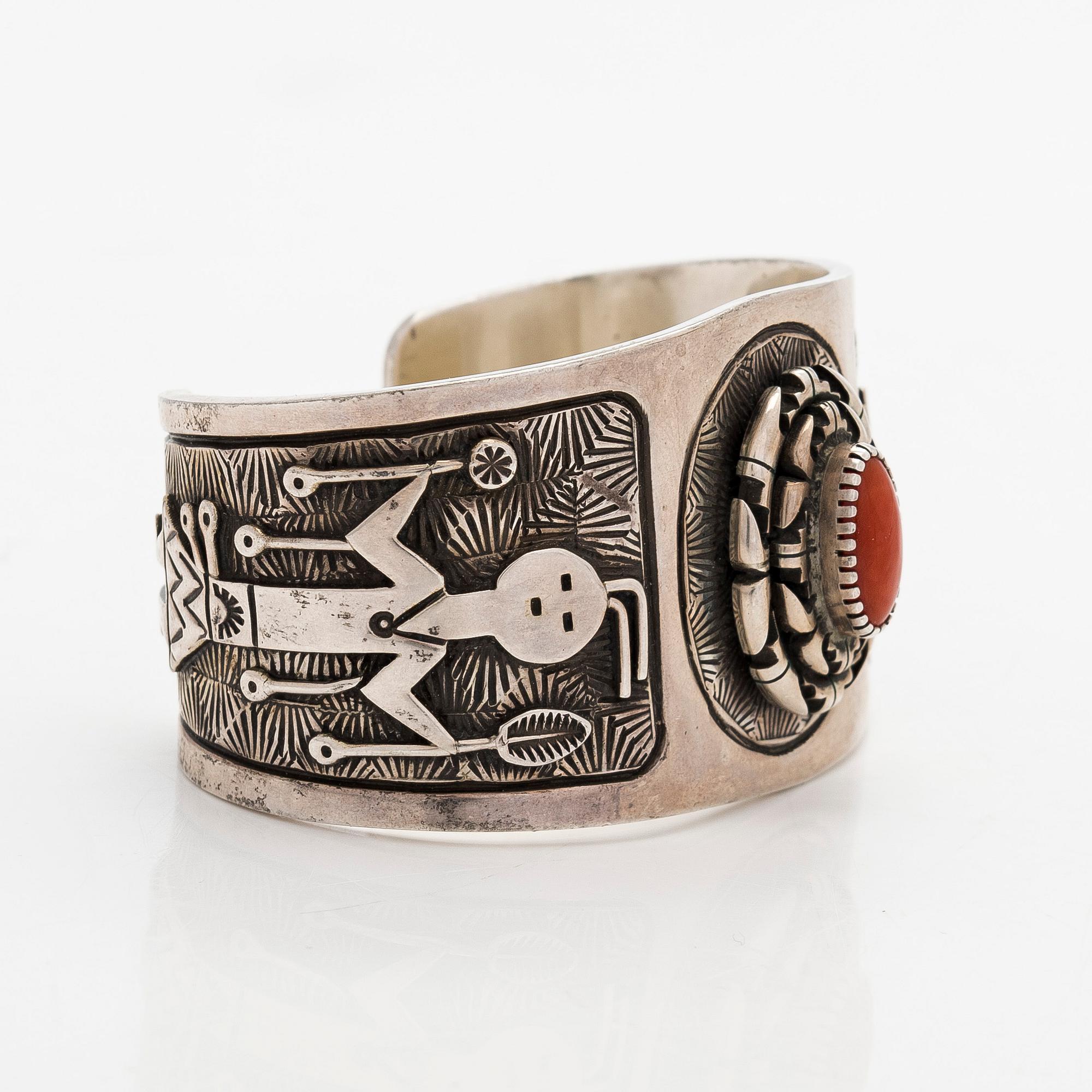 A silver bracelet with coral.