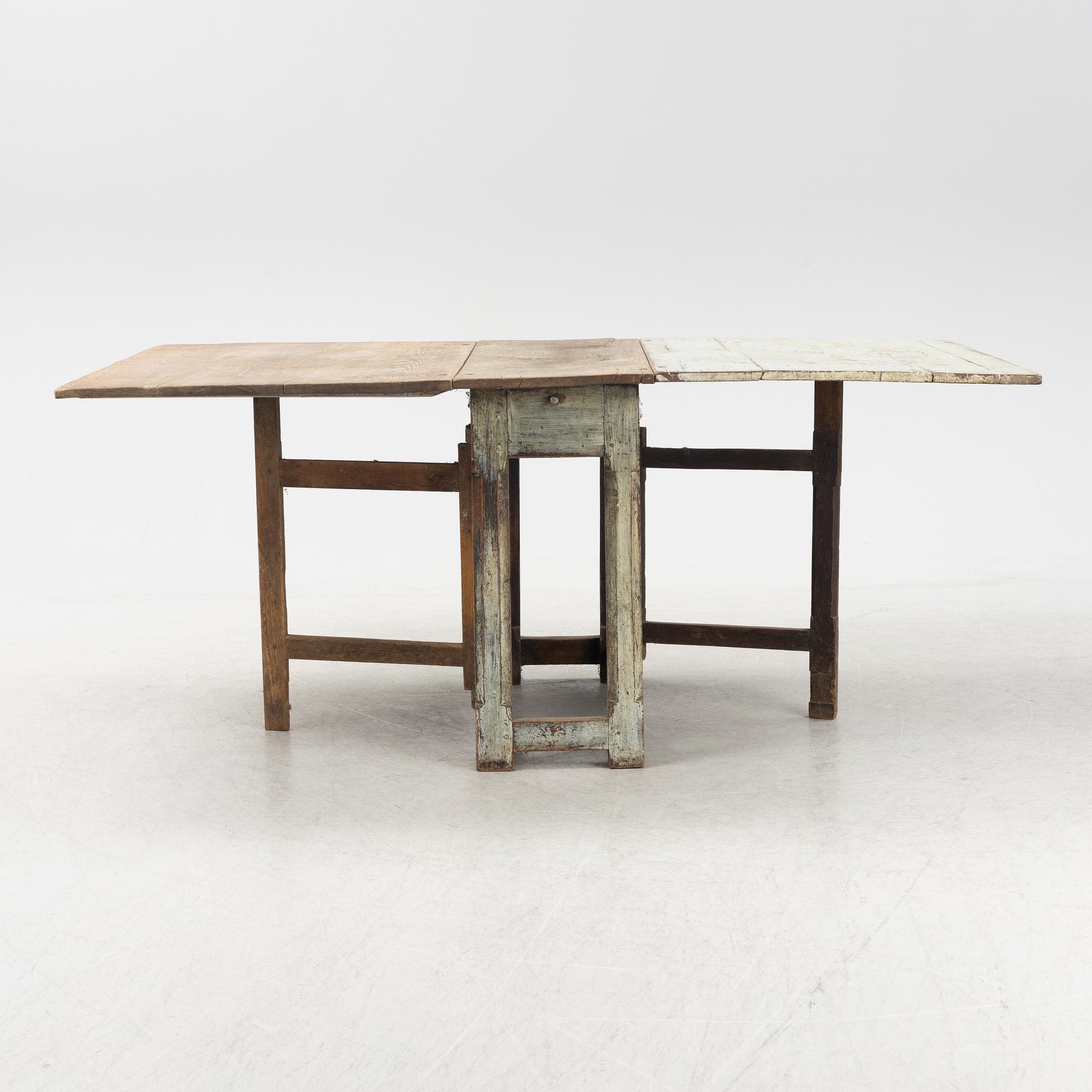 A 18th century gate-legged pine table.