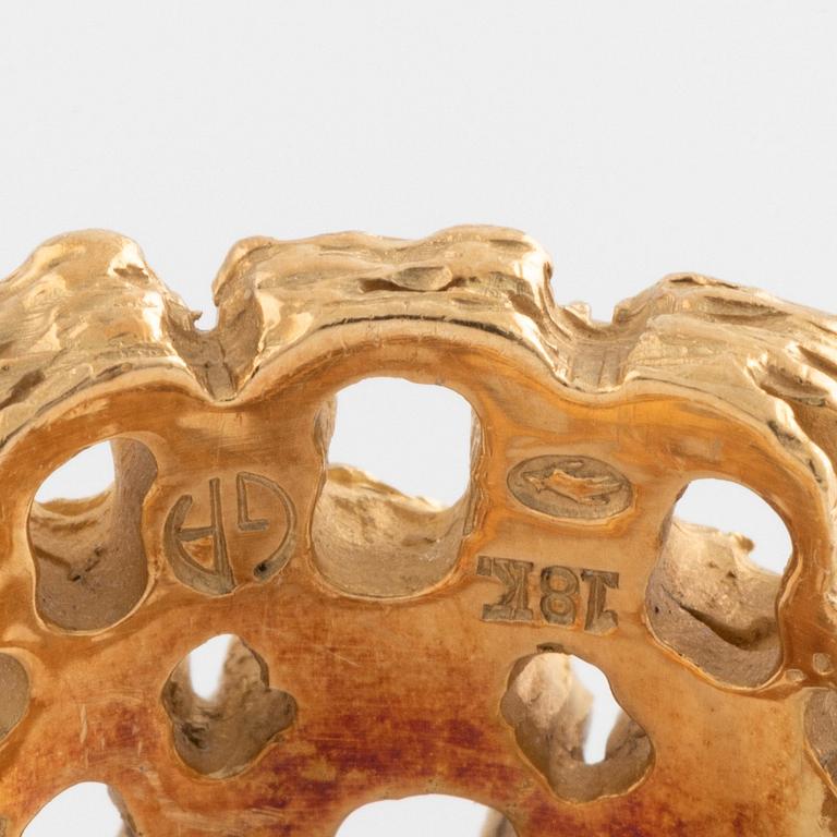 A Gilbert Albert ring in 18K gold.