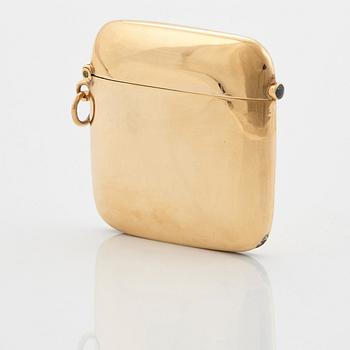 An 18K gold match case/pendant set with a faceted sapphire.