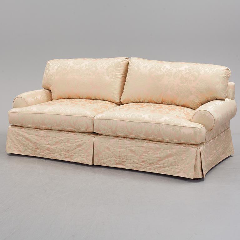 A sofa upholstered with silk damask.