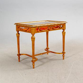 A gilded Louis XVI style display table first half of the 20th century.