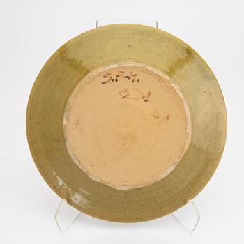 Signe Persson-Melin, a set of nine 1950s kopper glazed stoneware plates.