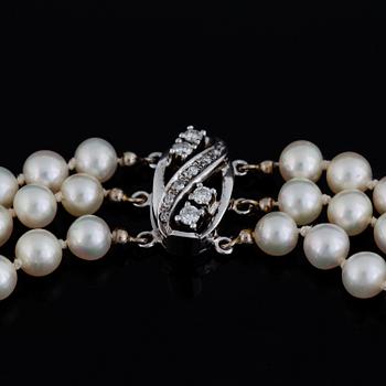 Three strand cultured pearl necklace, clasp with diamonds.