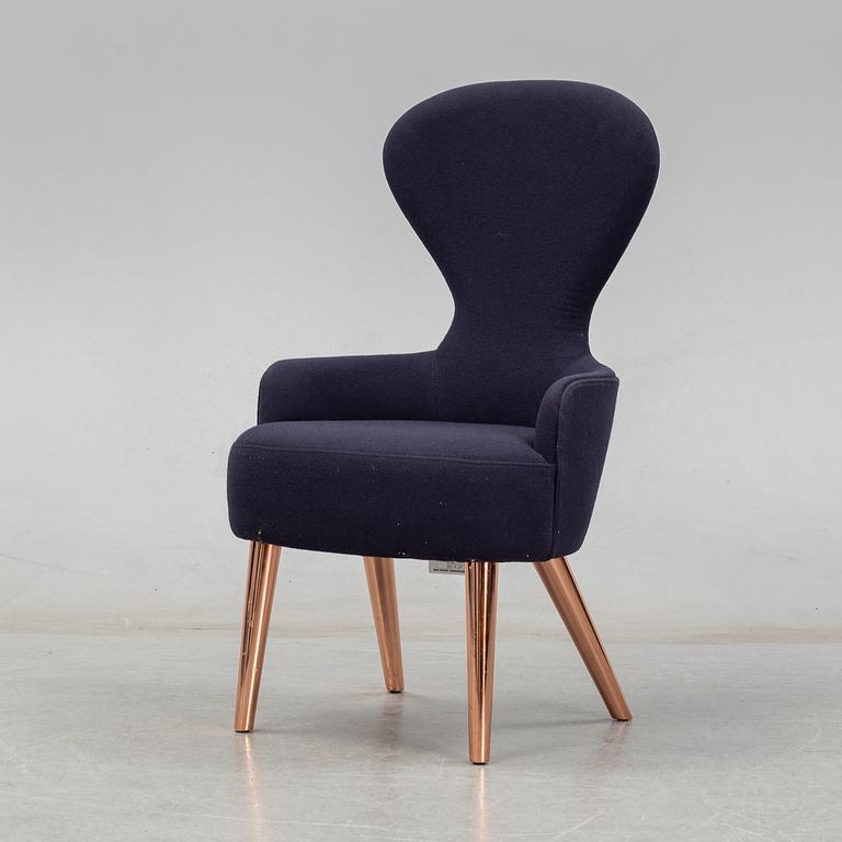 A Tom Dixon "Wingback Dining Chair" from Tom Dixon.