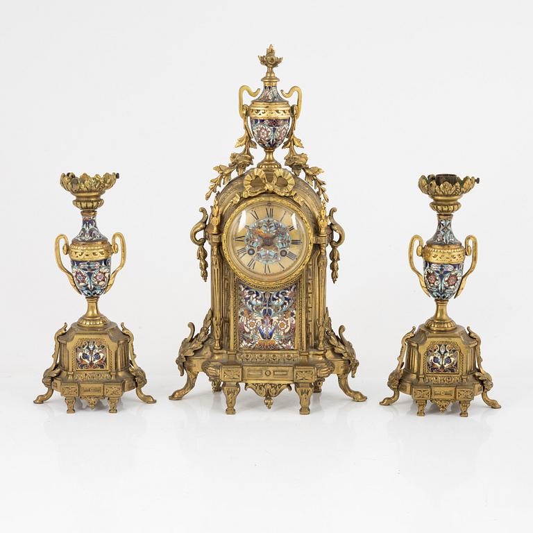 A set of two Louis XVI-style candle sticks and a mantle clock, late 19th century.