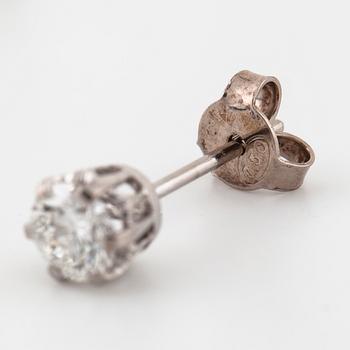 A pair of brilliant cut diamond earrings.