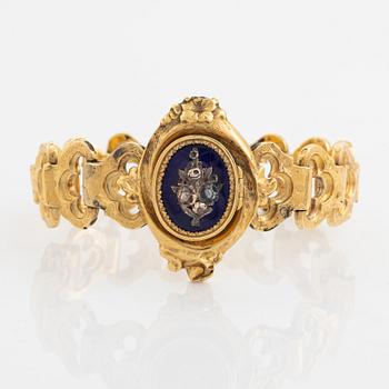 An 18K gold and blue enamel bracelet.