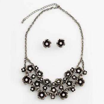 Necklace with matching earrings, white metal in floral design with glass stones.