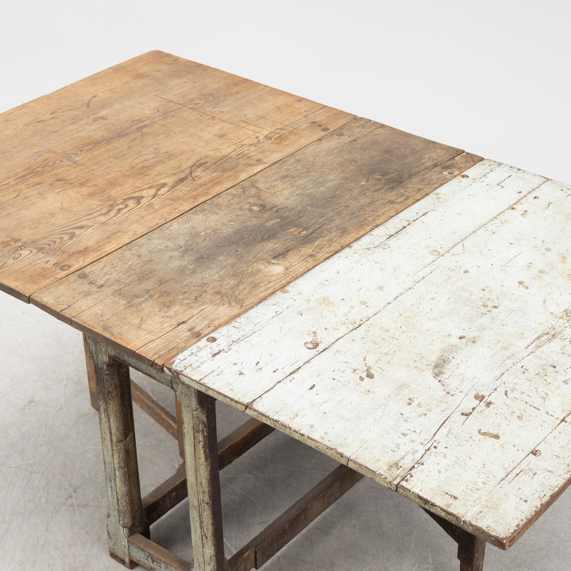 A 18th century gate-legged pine table.