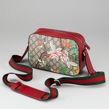 GUCCI, a patterned monogram canvas and leather bag.