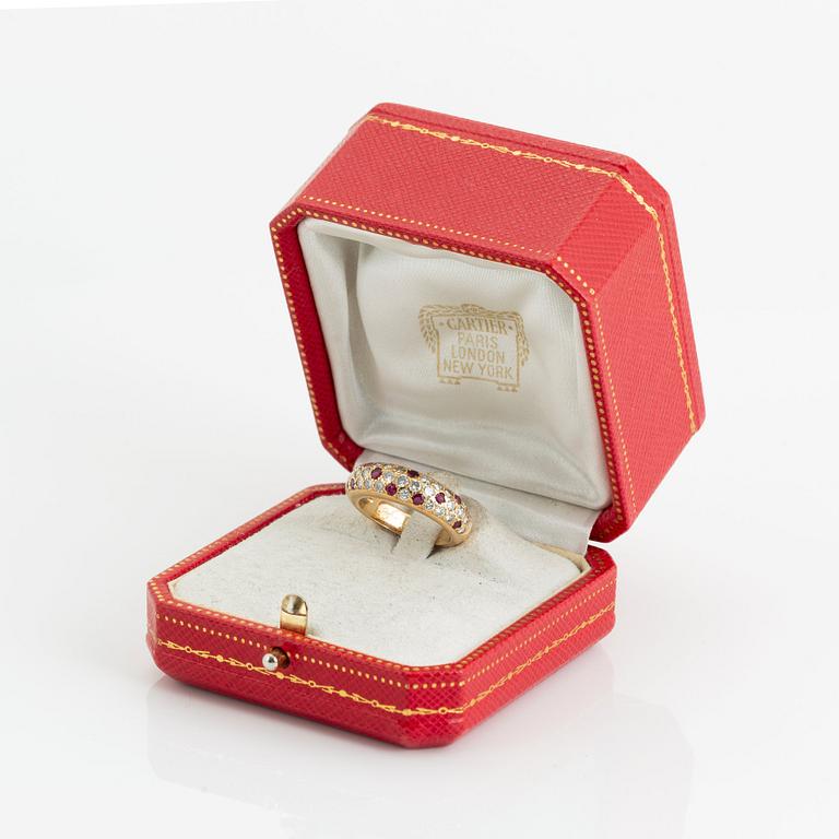 An 18K gold Cartier ring set with round brilliant-cut diamonds and rubies.