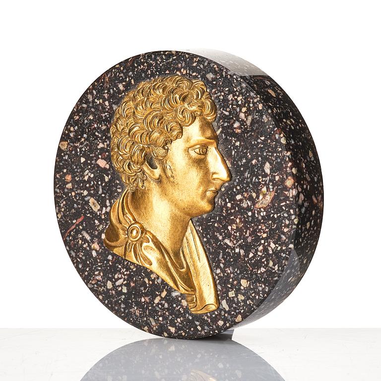 A Swedish porphyry paper weight with King Carl XIV Johan in profile.