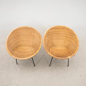 A pair of rattan 1950s easy chairs.