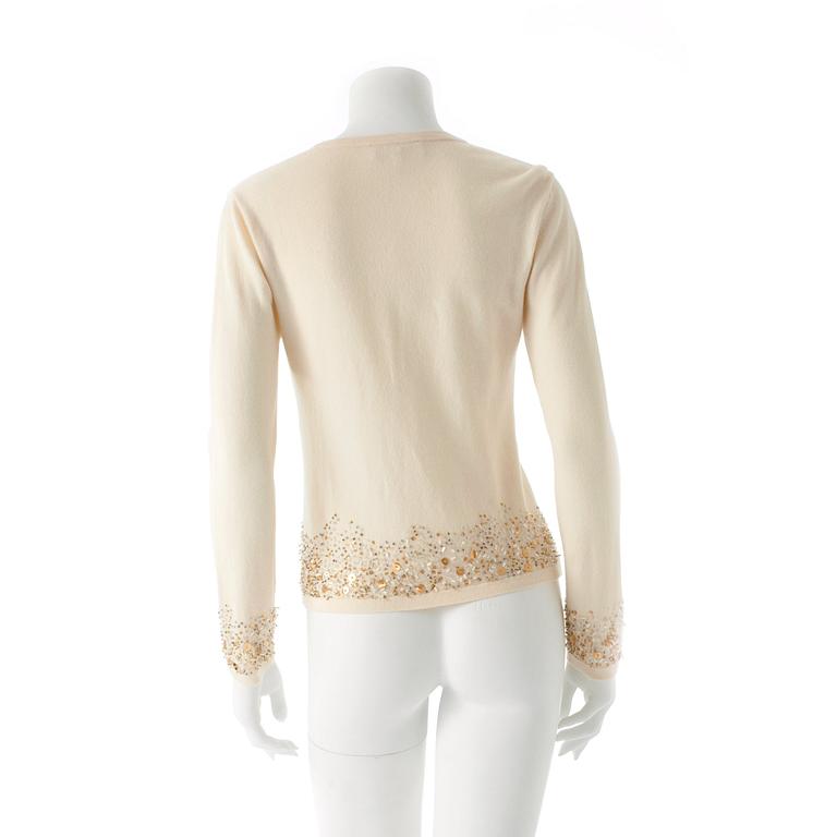 ESCADA, a creme colored wool and cashmere blend cardigan with sequin embellishment.