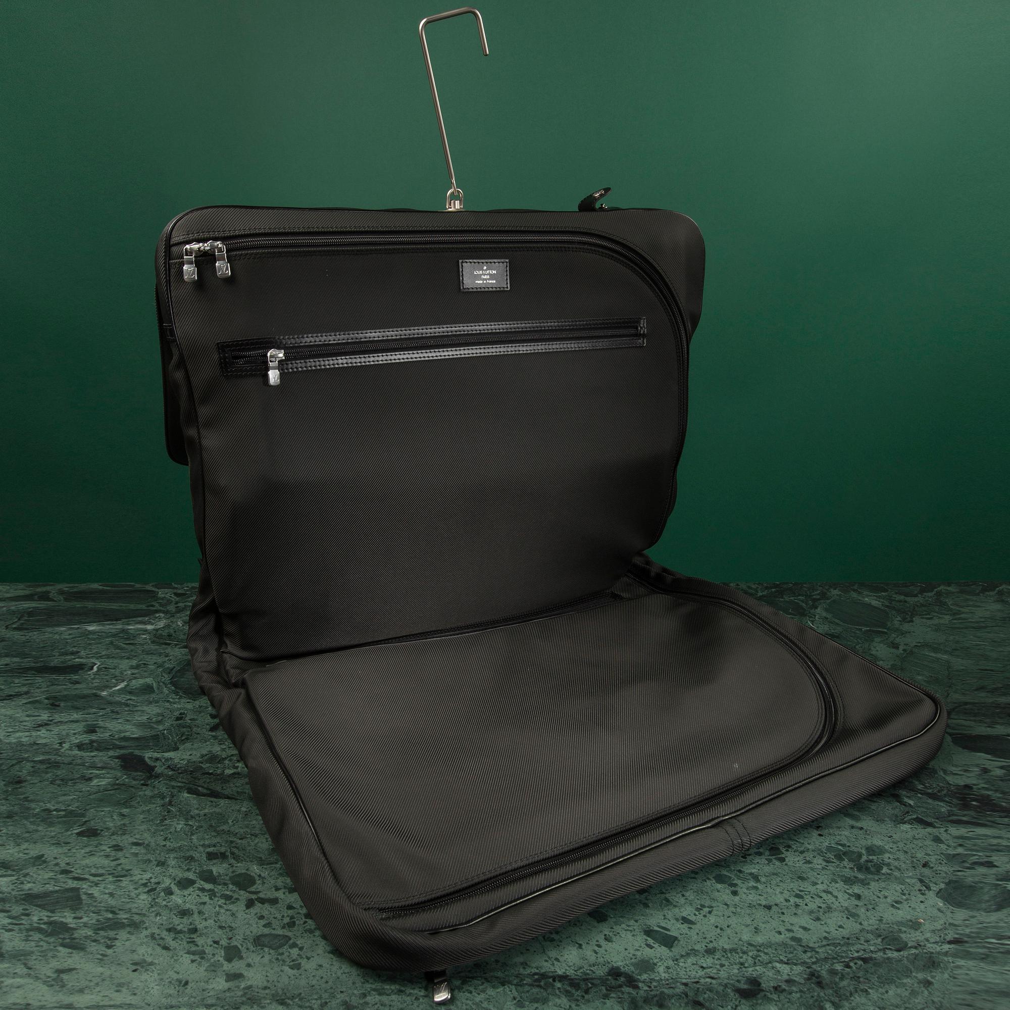 A Garment bag by Louis Vuitton.