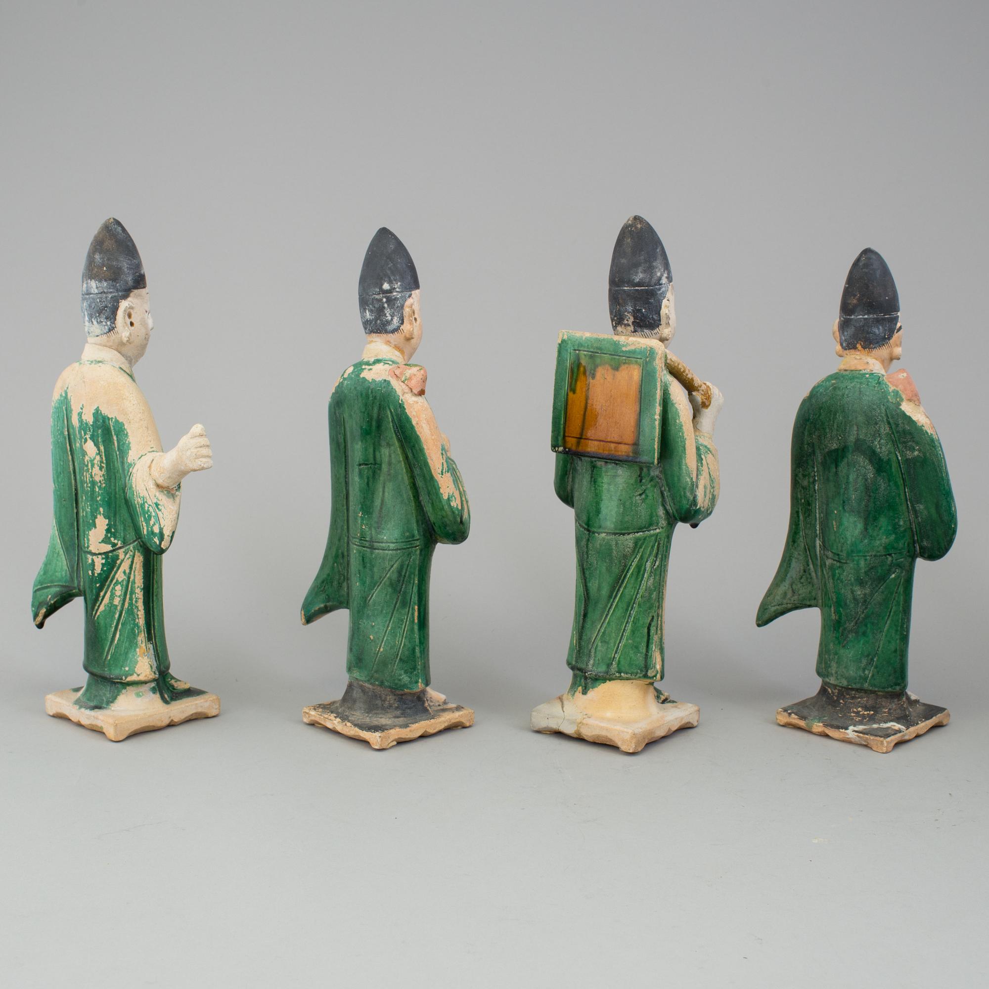 A group of eight chinese figures with three objects, earthenware, Ming dynasty.