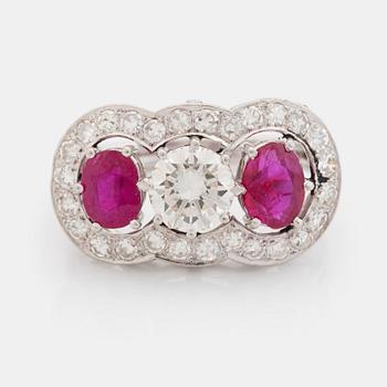 403. An 18K white gold ring set with faceted rubies and a round brilliant-cut diamond and eight-cut diamonds.