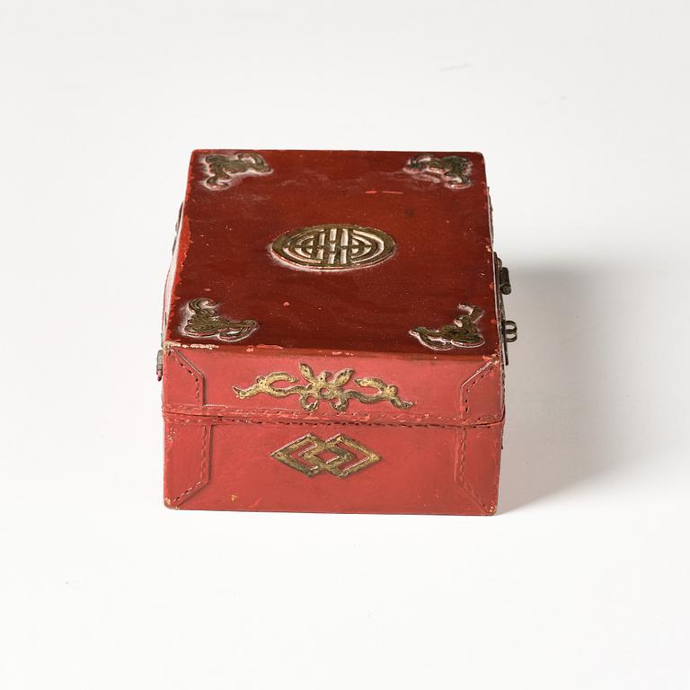 A set of two gilt decorated leather clad wooden chests, late Qing dynasty.