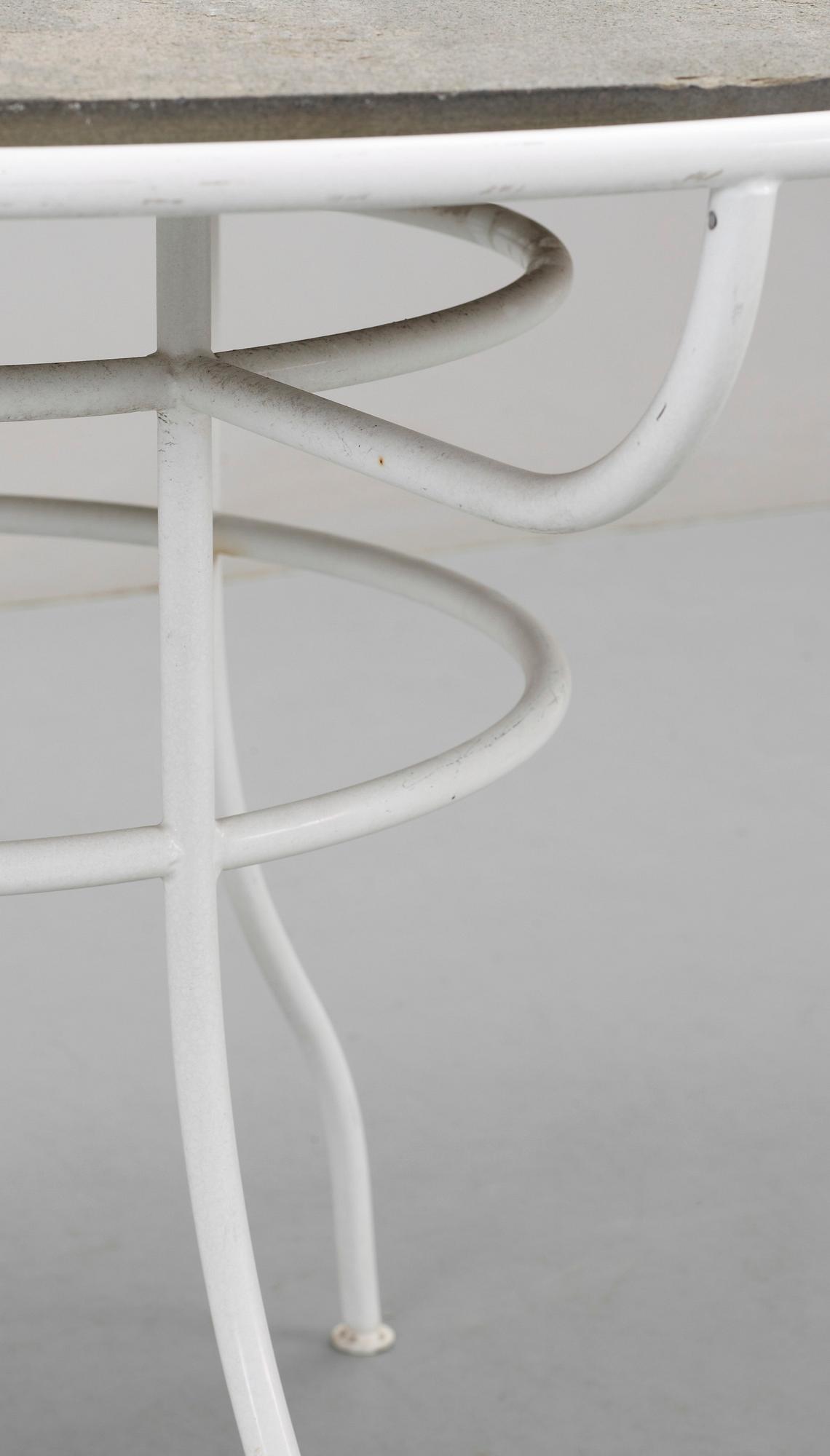 An Olle Rex lackered iron table with gray schist top by Svenskt Tenn.